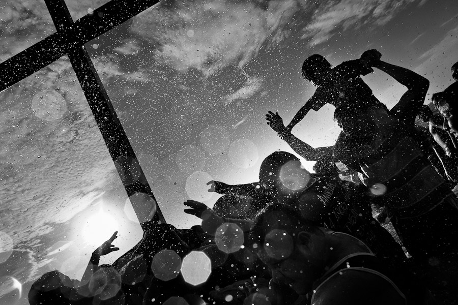 Catholic followers bath the wooden cross in the Pacific ocean during the annual Holy Week ritual.