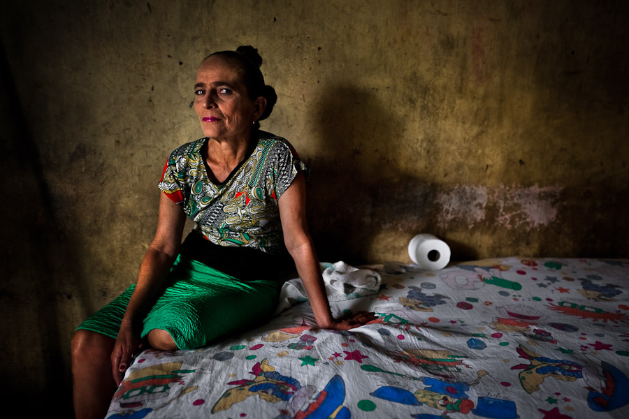 A Salvadoran sex worker poses for a picture in a room where her sexual services are offered to clients in San Salvador, El Salvador.