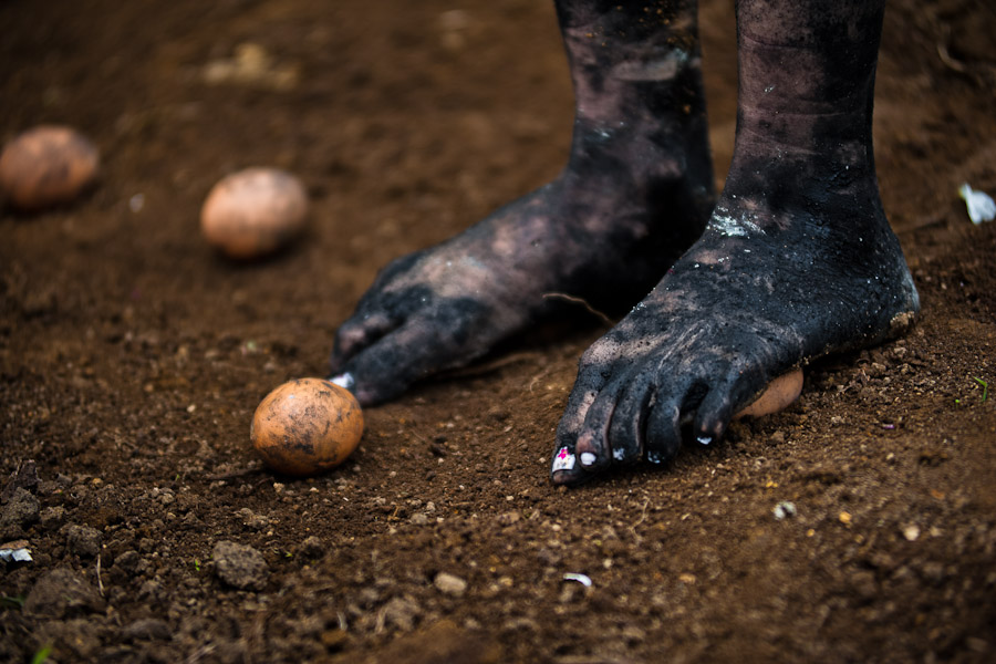 Diana R., who claims to be possessed by spirits, steps on eggs during a ritual of exorcism performed by Hermes Cifuentes in La Cumbre, Colombia.