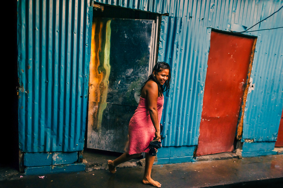 A Salvadoran sex worker leaves the room after providing sexual service to a client in a street sex bar in San Salvador, El Salvador.