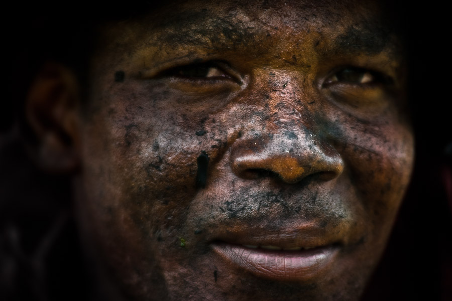A sugar cane cutter, having his face covered by ashes from the burned sugar cane, poses for a picture on the plantation in Valle del Cauca, Colombia.