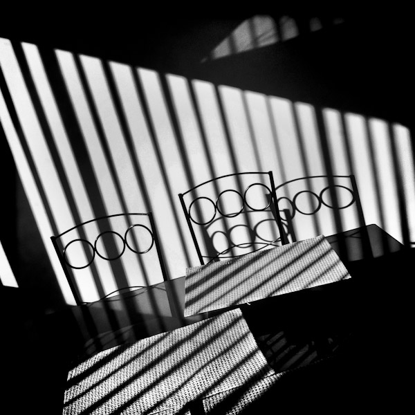 Shiny sunlight stripes are seen on the wall and on the table during the morning in an apartment in Quito, Ecuador.