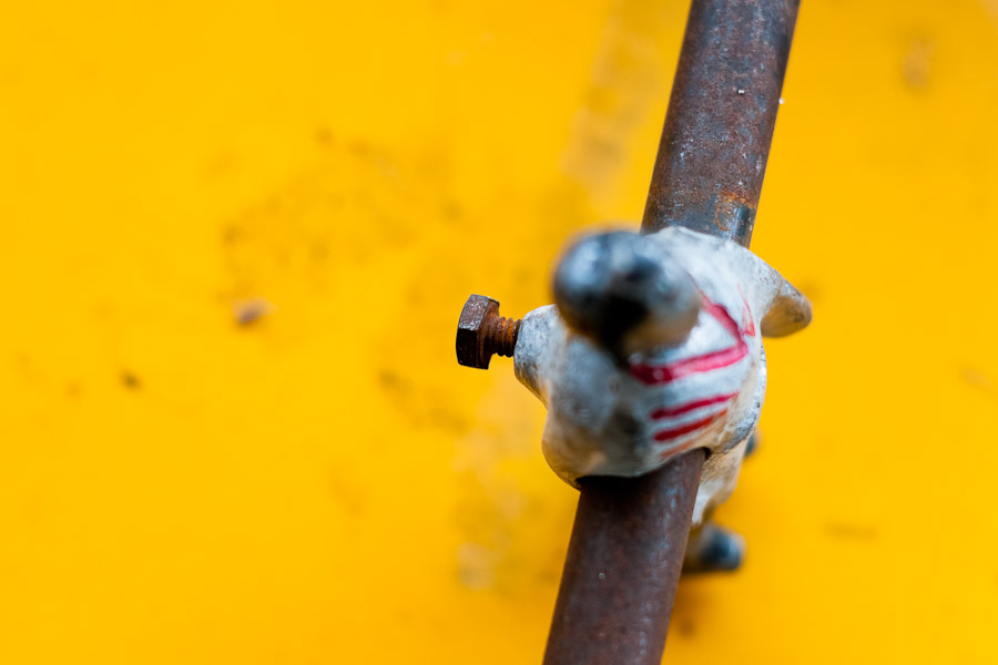 Futbolin player mounted on rusted bar.