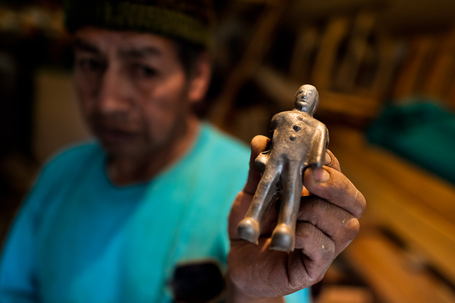 Fabian R., a carpentry worker, shows an unpainted figure of a player at a table football workshop in Quito, Ecuador.