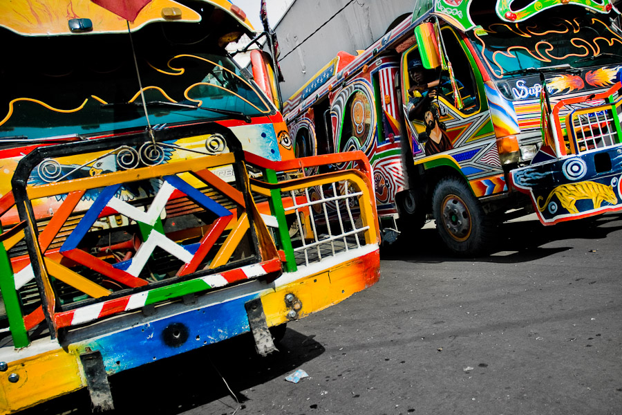 Tap-tap buses passing through the downtown of Port-au-Prince.