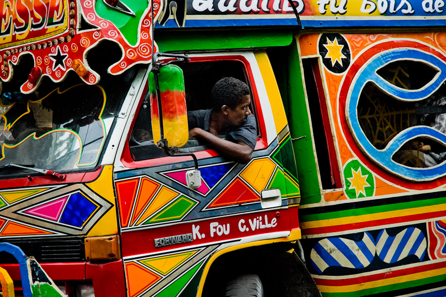 The tap-tap bus driver maneuvering his vehicle in heavy traffic of Port-au-Prince.