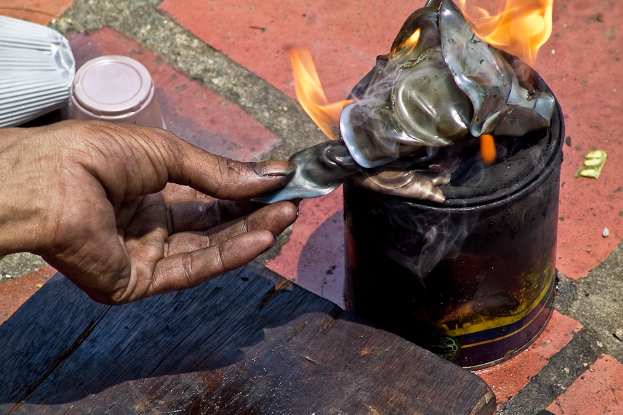 The technique is based on melting down the plastic cups in fire on a burner.