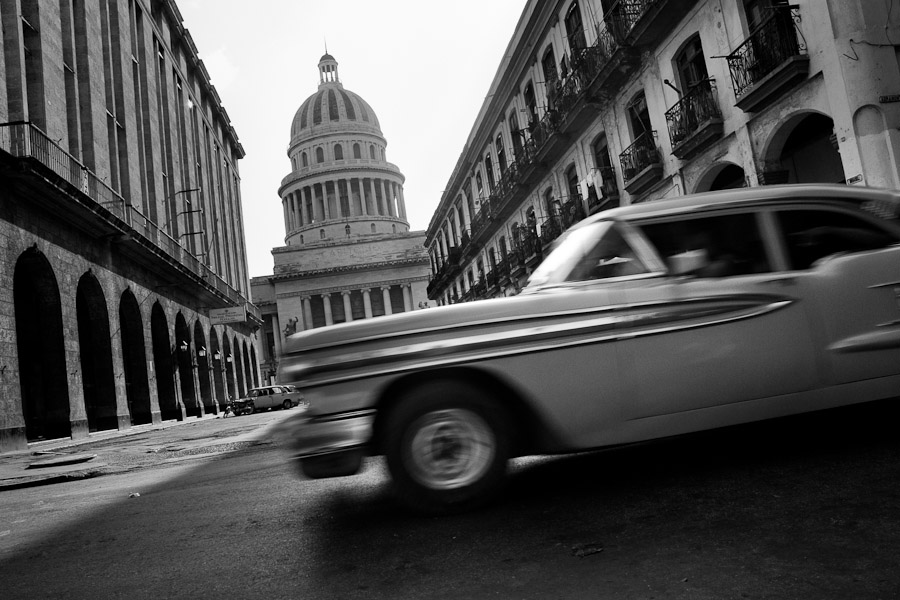 An American classsic car from the 1950s passing along the street in front of The Capitol (El Capitolio), Havana, Cuba.