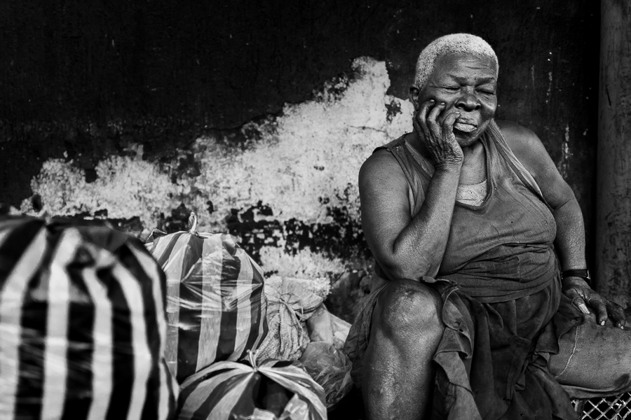 An Afro-Colombian charcoal worker takes a short nap break in a street market in Cartagena, Colombia.