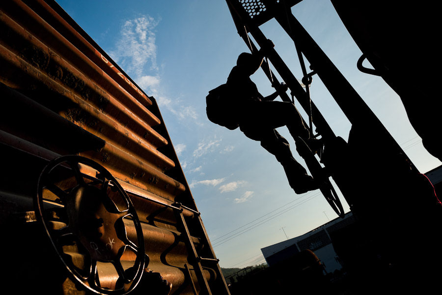 A young immigrant, heading from El Salvador to the United States, climbs up the cargo train called ‘El Tren de la Muerte’ (Train of Death) on a train station in Arriaga, Mexico.