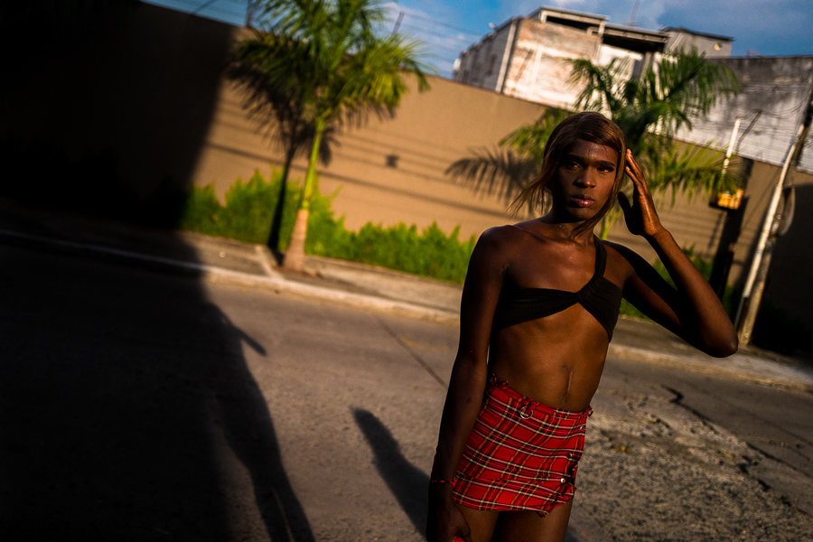 Britany, a Colombian transgender woman, poses for a picture while waiting for sex service clients in the street in Cali, Colombia.