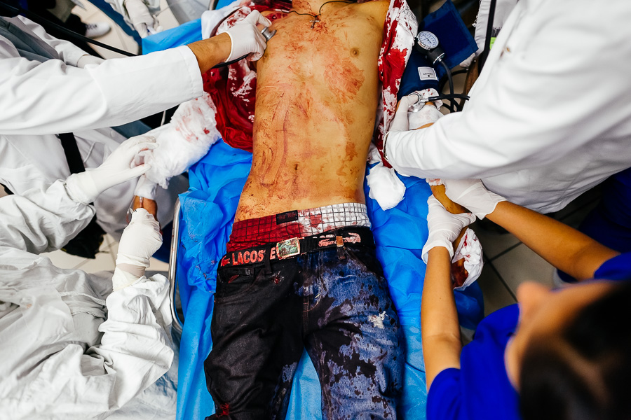 Physicians provide trauma resuscitation and medical care iin the emergency department of Hospital Rosales, a public hospital in San Salvador, El Salvador.