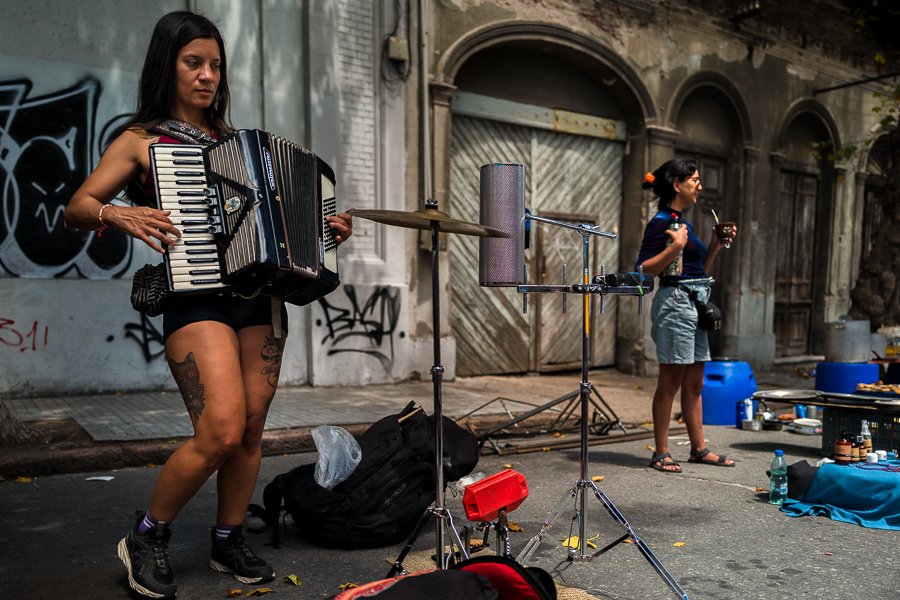 A young Uruguayan woman plays accordion at the Tristán Narvaja street market in Montevideo, Uruguay.