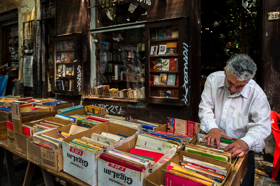 A Uruguayan man looks through old books and paperbacks in front of a bookstore at the Tristán Narvaja street market in Montevideo, Uruguay.