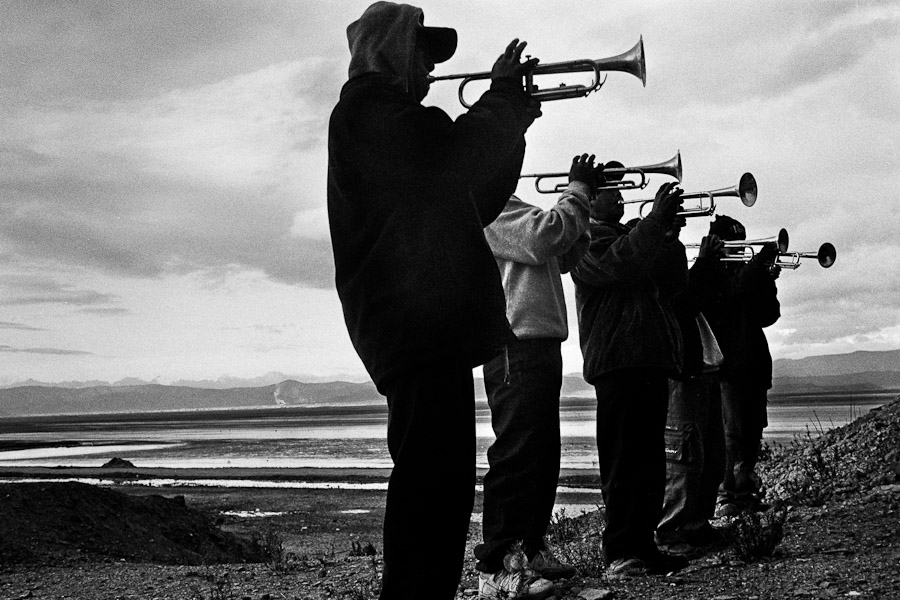 Bolivian boys play trumpets on a vast mountain plateau during the festival of Our Lady of Mount Carmel, Oruro, Bolivia.