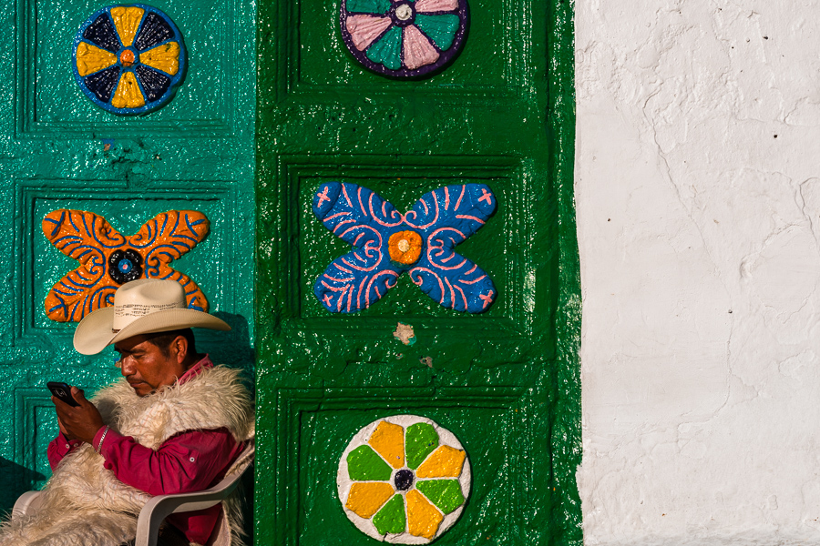 An indigenous Tzotzil Maya man sits in front of the church of San Juan Bautista in San Juan Chamula, Chiapas, Mexico.