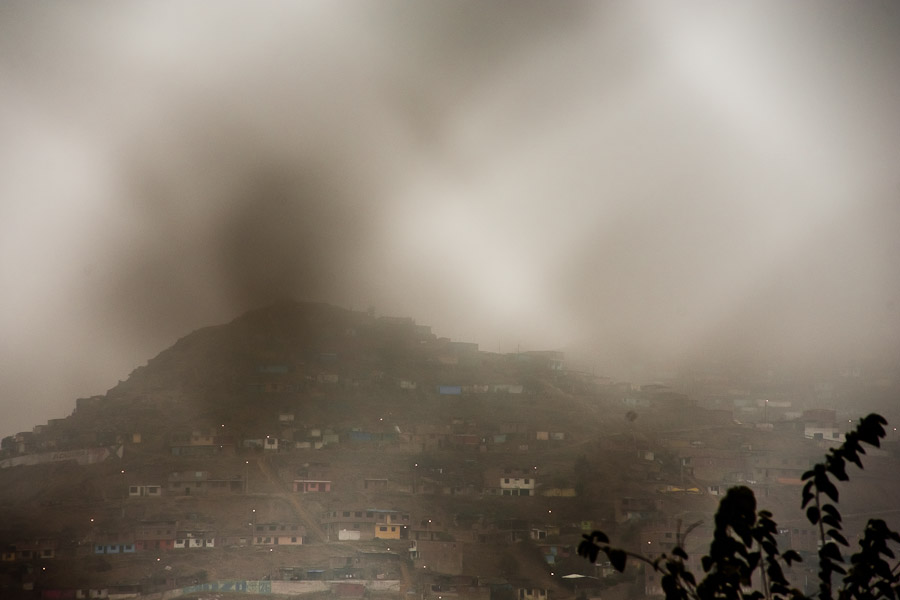 The urban horizon, with a shanty town built upon the hill, seen from the Boxeo VMT boxing club in an outdoor gym in Lima, Peru.