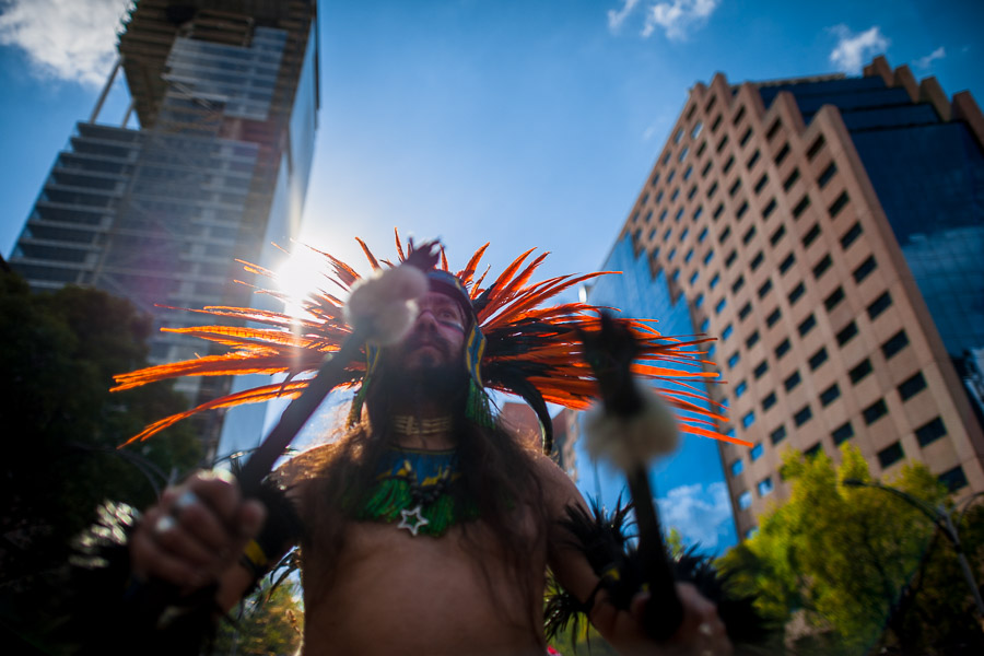 A Mexican man, wearing a colorful feather headgear inspired by Aztecs, plays drum during the Day of the Dead (Día de Muertos) celebrations in Mexico City, Mexico.