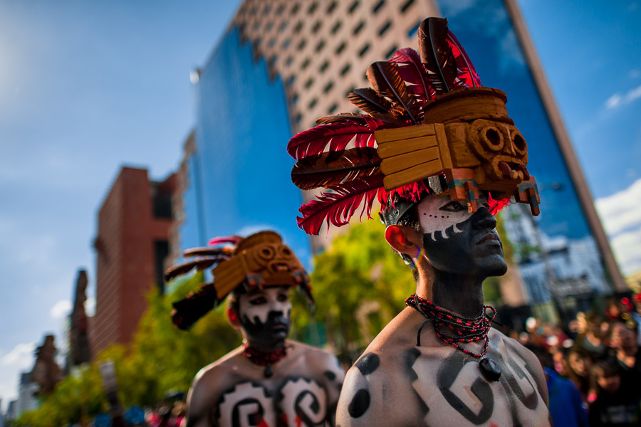 Mexican men, wearing colorful feather masks inspired by Aztecs, take part in the Day of the Dead (Día de Muertos) procession in Mexico City, Mexico.