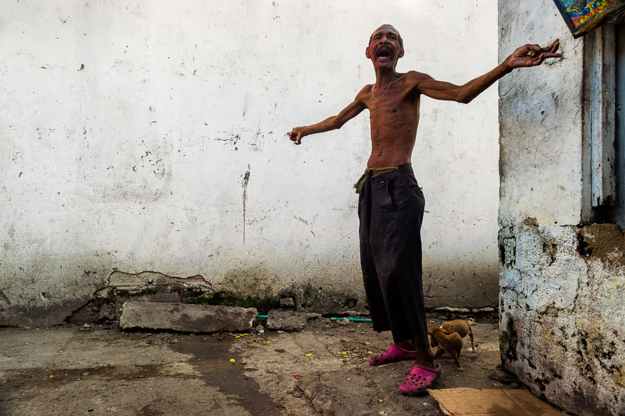 A mentally ill man is seen during the verbal dispute with an imaginary person in a back alley in Cartagena, Colombia.