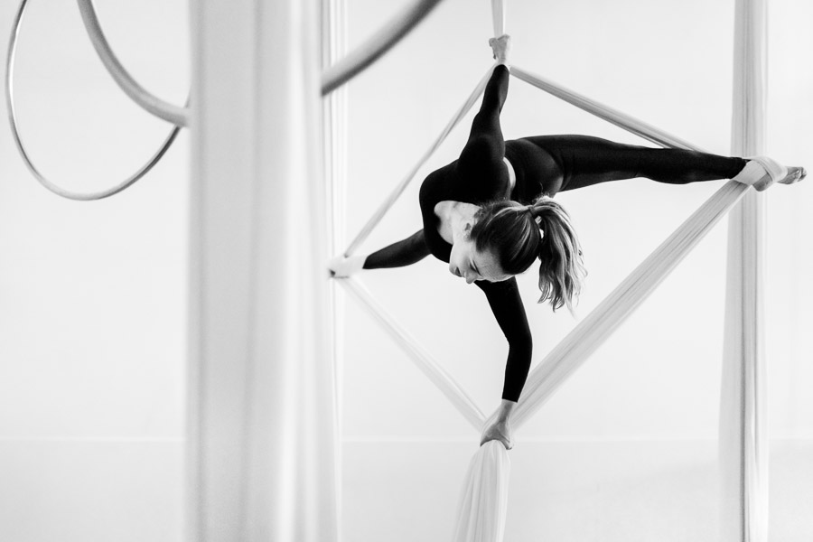 A Colombian aerial dancer performs a balance trick on aerial silks during a training session in a gym in Medellín, Colombia.