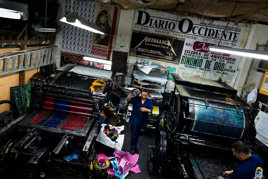 Colombian master printers prepare the ancient letterpress machines for a new load in the print shop in Cali, Colombia.