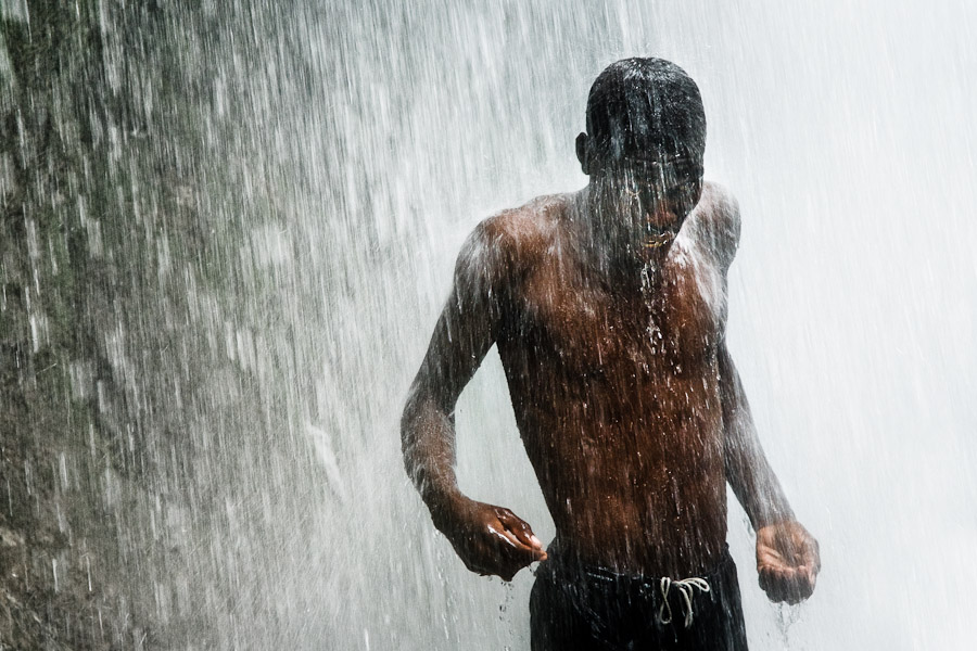 A Haitian man performs a bathing and cleaning ritual under the waterfall during the annual religious pilgrimage in Saut d'Eau, Haiti.