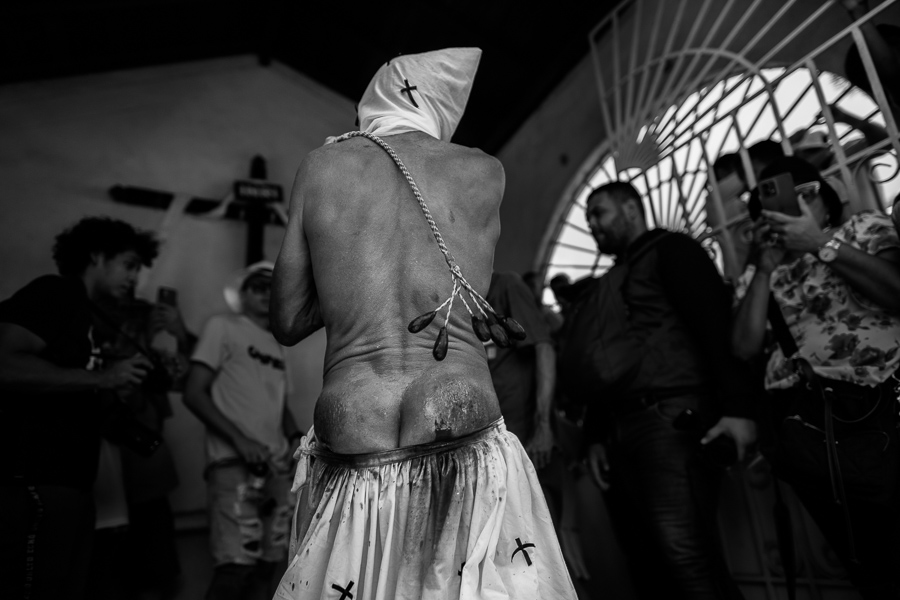An Afro-Colombian man whips himself during a penance ritual as part of the Holy Week religious procession in Santo Tomás, Colombia.