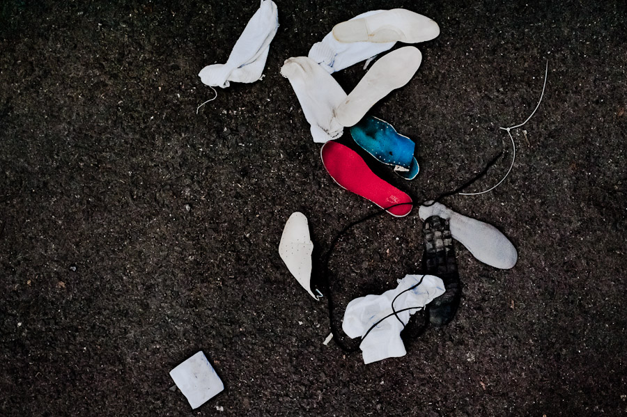 White socks and insoles of alleged Mara gang members are seen thrown away after the initial search on the yard at the detention center in San Salvador, El Salvador.