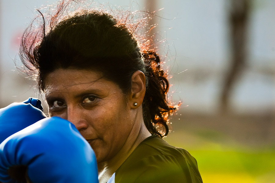 A Peruvian woman practices defense while training in the outdoor boxing school at the Telmo Carbajo stadium in Callao, Peru.