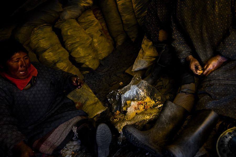 Pallaqueras, female gold miners, eat lunch in their shelter close to the gold mines in La Rinconada, Peru.