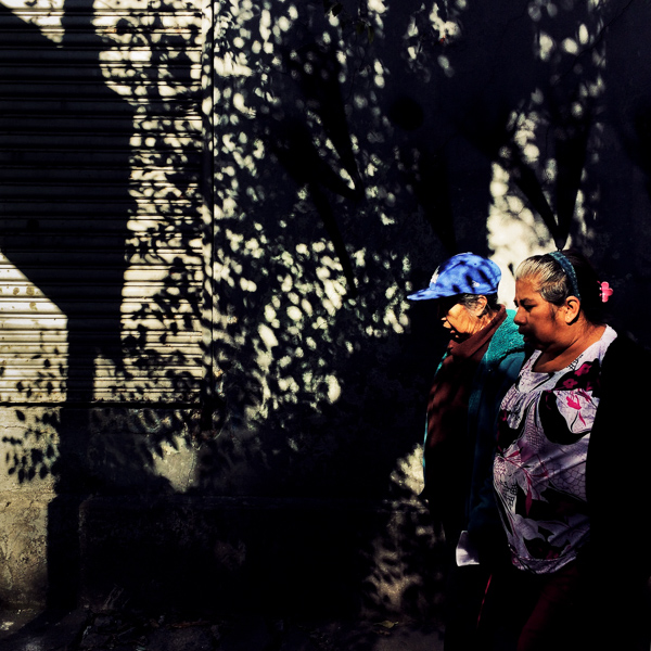 Mexican women walk along the street during a sunny morning in Buenavista, a neighborhood in Mexico City, Mexico.