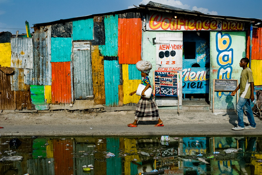 A Haitian woman walking down the street in the La Saline market (Port-au-Prince, Haiti).