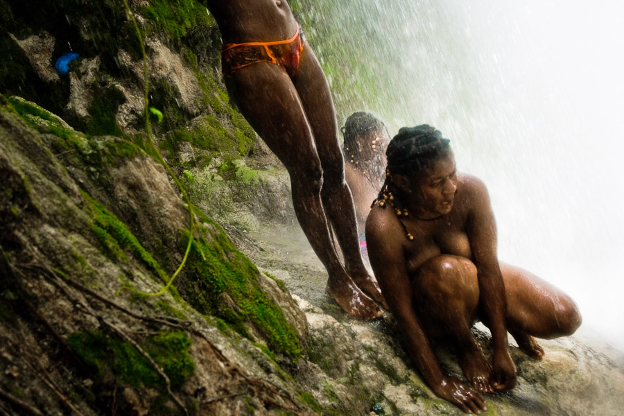 Haitian women perform a bathing and cleaning ritual under the waterfall during the annual religious pilgrimage in Saut d'Eau, Haiti.