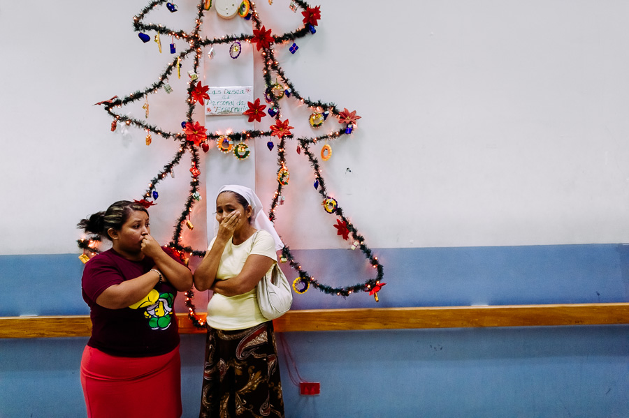 Salvadoran women cry in the hospital corridor as they brought a deadly injured family member to the emergency department of a public hospital in San Salvador, El Salvador.