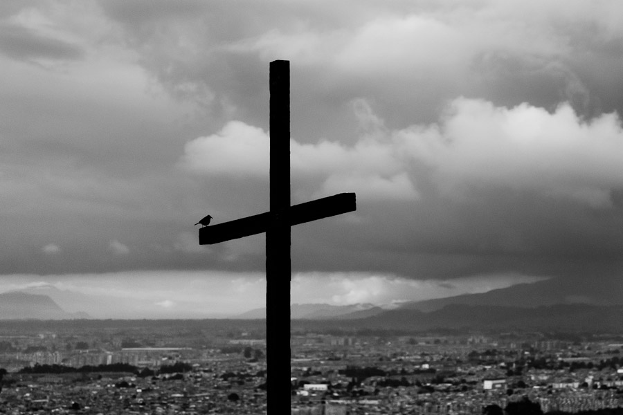A wooden cross, pointing out a local church, is seen placed above the large outskirts in the south of Bogota, Colombia.