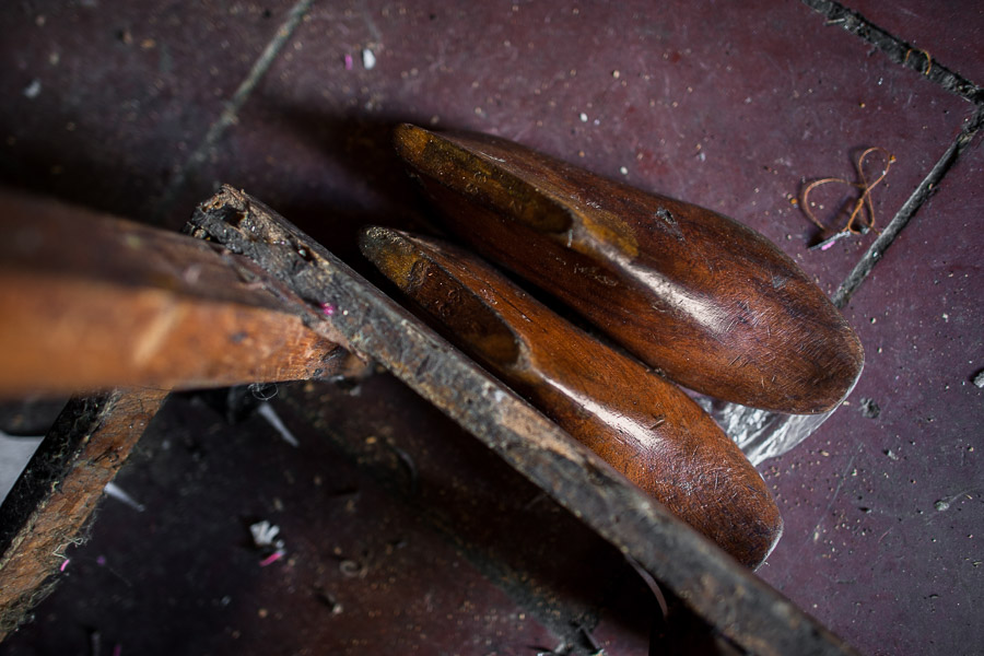 A pair of vintage wooden shoe lasts is seen on the floor of a small shoe making workshop in San Salvador, El Salvador.