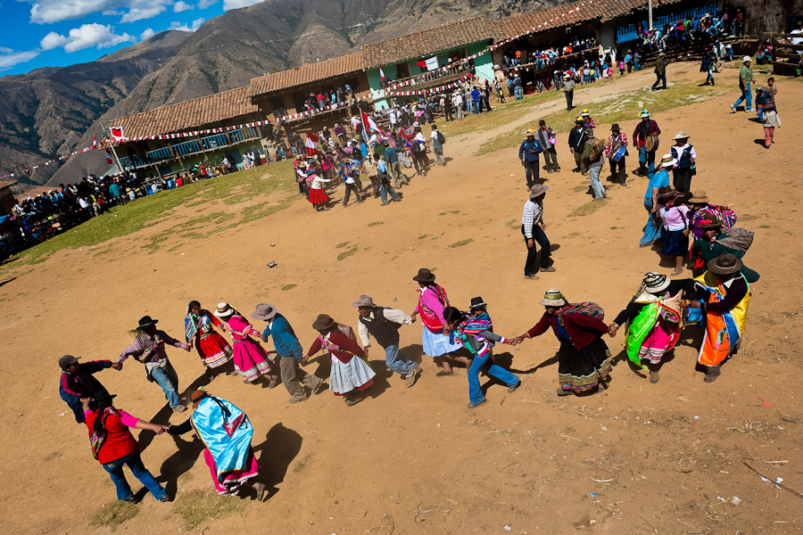 Peruvian peasants dance in the bullring before the Yawar Fiesta, a ritual fight between the condor and the bull, held in the mountains of Apurímac, Peru.